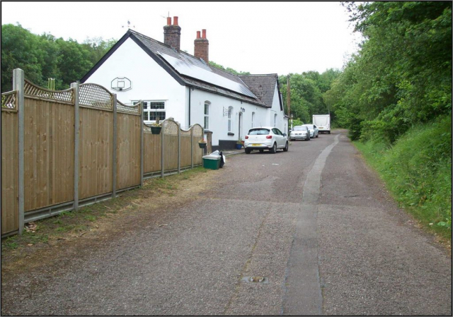 Venn Cross was ruled by the Railway Clearing House “Hand-Book of Stations” to be in Devon, yet the scout is standing on the county boundary looking into Somerset. A “cat’s eye” tells of this once being a busy road. Devon & Somerset Railway