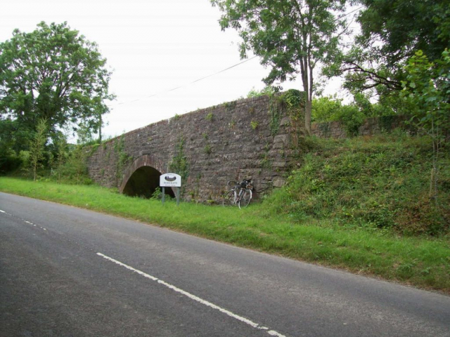 The bridge which carried the B3190 over the Barnstaple Branch near Morebath Junction is now partly filled in and bypassed. Devon & Somerset Railway