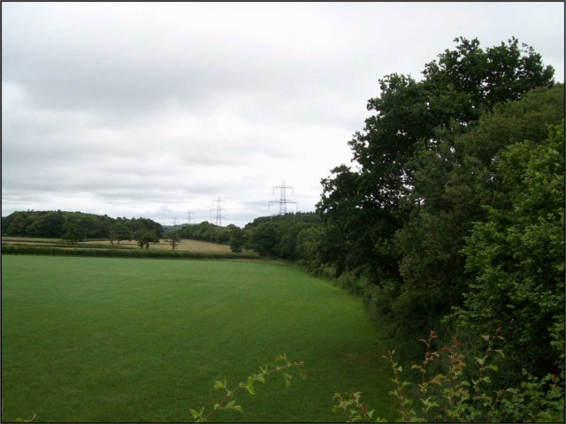 From the bridge, an unmistakeable railway curve, actually continuing as a mile-long straight, gives away the course of the line towards Taunton. It is shadowed by a line of pylons. Devon & Somerset Railway