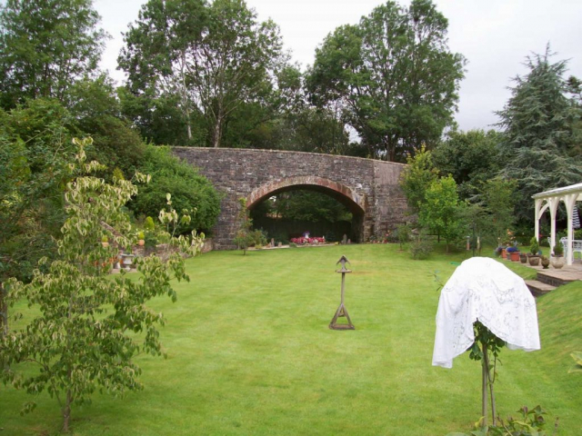 The bridge carries the road to Dulverton and Exmoor; the town is two miles away to the right. Devon & Somerset Railway
